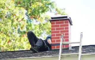 Asphalt tile roof with chimney on new home under construction